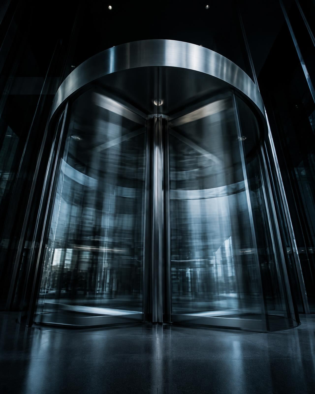 Glass revolving door in a modern lobby